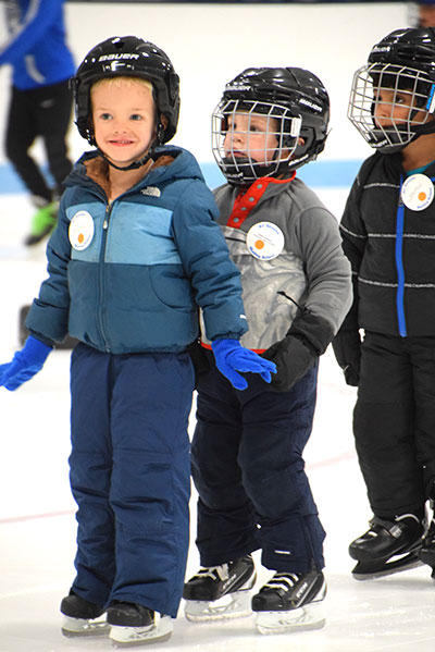 Three kids on ice skates