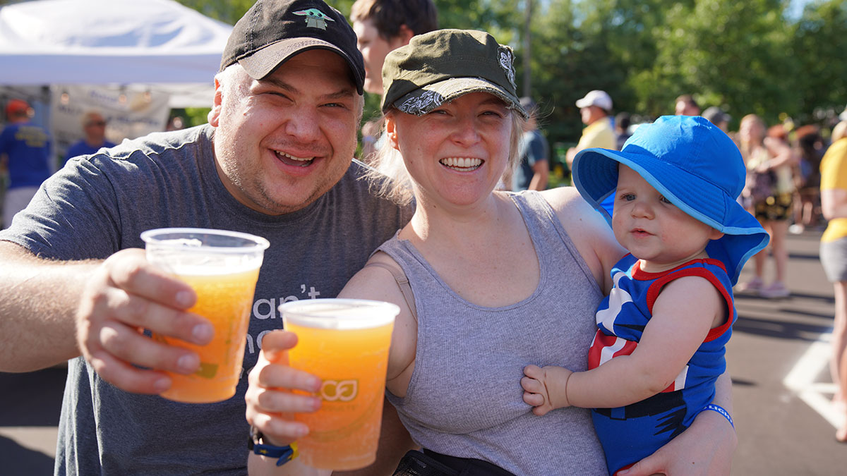 Adults holding beverages and smiling