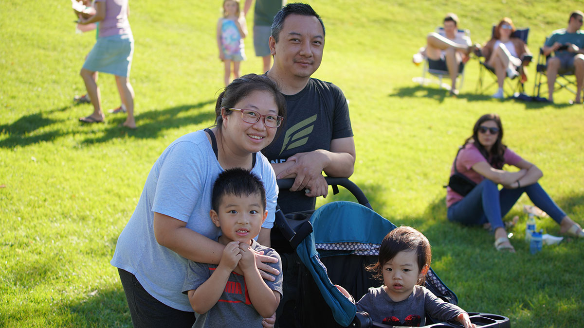 Man and woman with child and stroller