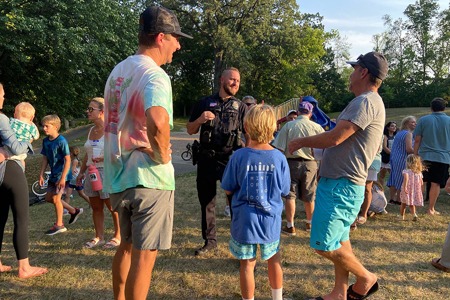 Police officer talking to people in a park