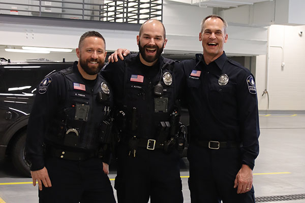 Three officers smiling