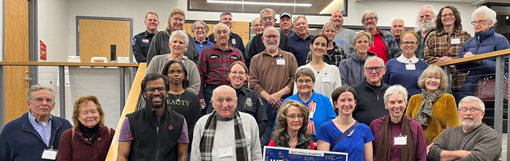 Large group of people standing on stairs posing for photo