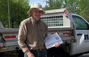 Man with hat and clipboard