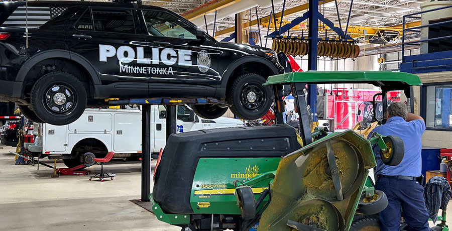 Police truck on lift and lawn mower