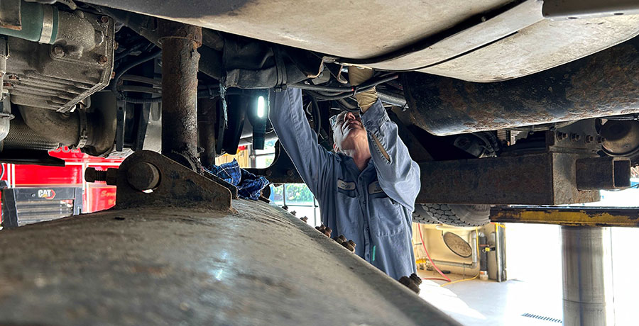 Man under truck on lift