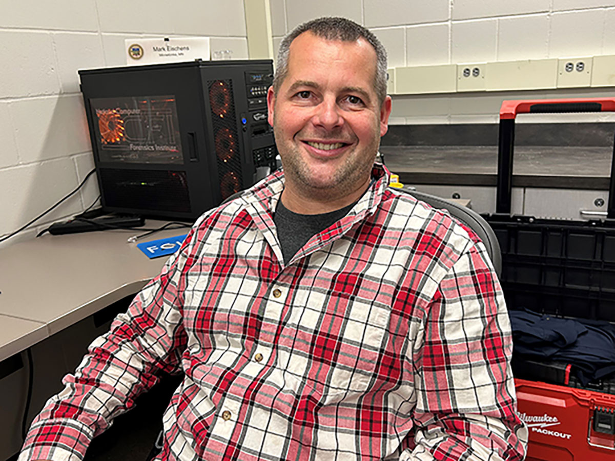 Man in red plaid shirt in office